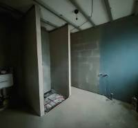 Interior of a family house with an unfinished bathroom and installations for a toilet and sink.