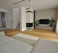 Living room in a family house with a fireplace and a wooden decor floor.