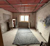 A room under renovation in a family house with a wooden decor floor.