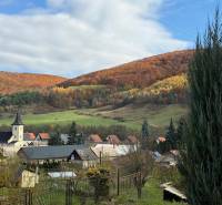 A church and family houses in the picturesque autumn landscape of Stará Kremnička.