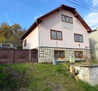 A family house in Stará Kremnička with a sloping garden and a stone facade.
