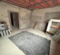 The interior of a family house in Stará Kremnička with exposed walls and floor.