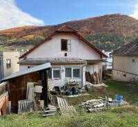 A family house in Stará Kremnička with a wooden shelter and a beautiful mountain backdrop.