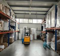 Warehouses and halls full of pallets and packages, a visible forklift.