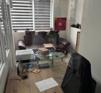 Office in warehouses and halls with a desk and wooden decor flooring.