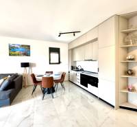 Bright kitchen with a dining table and a comfortable sofa in a studio apartment.