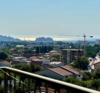 A view of the city of Bar with a sea view and construction cranes.