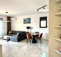 Living room with a comfortable corner sofa and a dining table in a studio apartment.