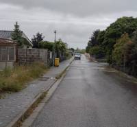 Street in Limbach with houses and a sidewalk, suitable for residential plots.