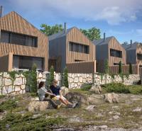 Family houses in Turecká with wooden cladding surrounded by nature and stone walls.