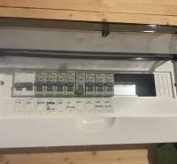 Electrical distribution cabinet in a cabin with a wooden decor floor.