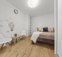 A bedroom in a two-room apartment with wall decor and a wooden floor decor.