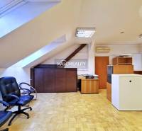 Offices with wood-patterned flooring, office chairs, and furniture.