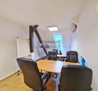 Offices with a desk, leather chairs, and a board. Floor with wooden decor.