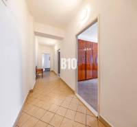 A hallway with tiles and an entrance to a room in a 4-room apartment.