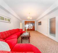 Red sofa, glass table, built-in cabinet, and light carpet in a 4-room apartment.