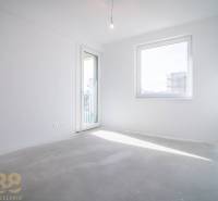 A bright room with balcony doors, with a view in a 2-room apartment.