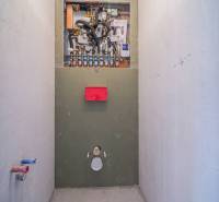 Installation of sanitary equipment in a 2-room apartment with a wooden decor floor.