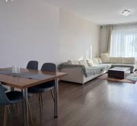Living room in a 4-room apartment with a wooden decor floor and a sofa.