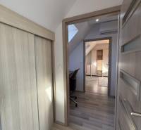 A hallway with a built-in wardrobe and a floor with a wooden decor in a 4-room apartment.