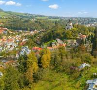 Aerial view of Banská Štiavnica with forested lands - housing and historical buildings.