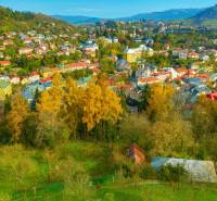 Aerial view of Banská Štiavnica with forests and residential properties on land designated for housing.