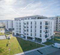 An apartment complex in the city of Poprad with three floors and outdoor parking.