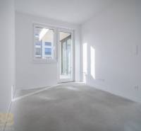 A bright room with white walls and large windows in a 3-room apartment.