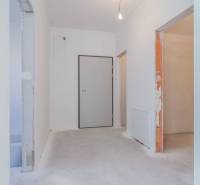 The entrance hall of a 3-room apartment with white walls and light flooring decor.
