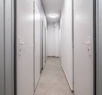 A narrow corridor with multiple white doors, suitable for a 2-room apartment.