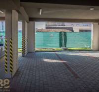 Garage parking for a 3-room apartment in Poprad with a paved floor and ramp.