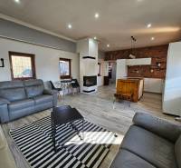 Living room of a family house with a wooden decor floor and a fireplace.