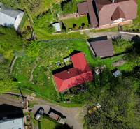 Aerial view of family houses, gardens, and streets in Štiavnické Bane.