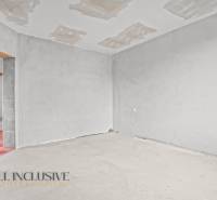A room in a family house with an unfinished floor and ceiling.