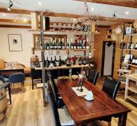 Commercial premises with a wine assortment, wooden furniture, and a floor with a wooden decor.