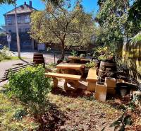 Garden with wooden seating and greenery on Prokopa Veľkého Street, Bratislava - Staré Mesto.