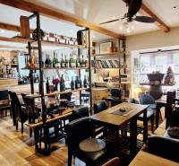 Commercial premises with equipment, wine bar, and wooden decor flooring.