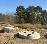Concrete structures for living, Studienka, Pod Borovicou, surrounded by vegetation and trees.