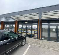 Commercial premises on Brnianska Street in Trenčín with a glass facade and parking lot.