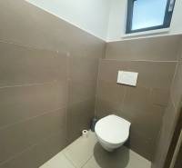 A restroom with a window and tiled floor in commercial premises.