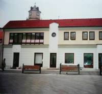 Commercial premises on Štúrovo Square in Trenčín with a tower in the background.
