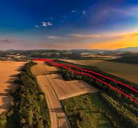 Agricultural and forest lands in Rokycany at sunset, with a visible red line.