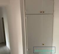 White built-in storage and tiles in a 2-room apartment.