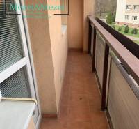 A narrow balcony terrace in a 2-room apartment with terracotta flooring and a view of the street.