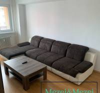 A sofa set with a coffee table in a 2-room apartment, floor with wooden decor.