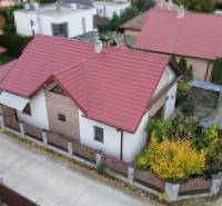 A family house on Košariská Street in Rovinka with a red roof and a garden.