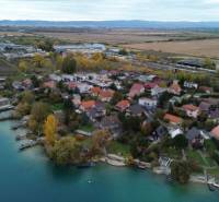Aerial view of family houses in Rovinka at Košariská near the lake with natural scenery.