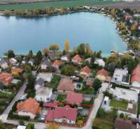 Aerial view of Košariská in Rovinka with family houses by the lake.