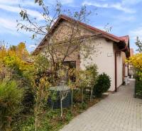 Family house on Košariská Street in Rovinka with an access road and vegetation.
