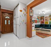 A hallway in a family house with colorful decorations and a colorful living room.